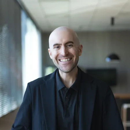 Headshot of Alex Scharf smiling at the camera