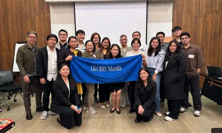 Attendees gathered with a GLOBIS Manila banner at the front of the classroom.