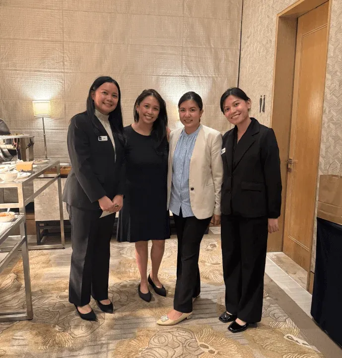Four attendees posed together during a break at the session.